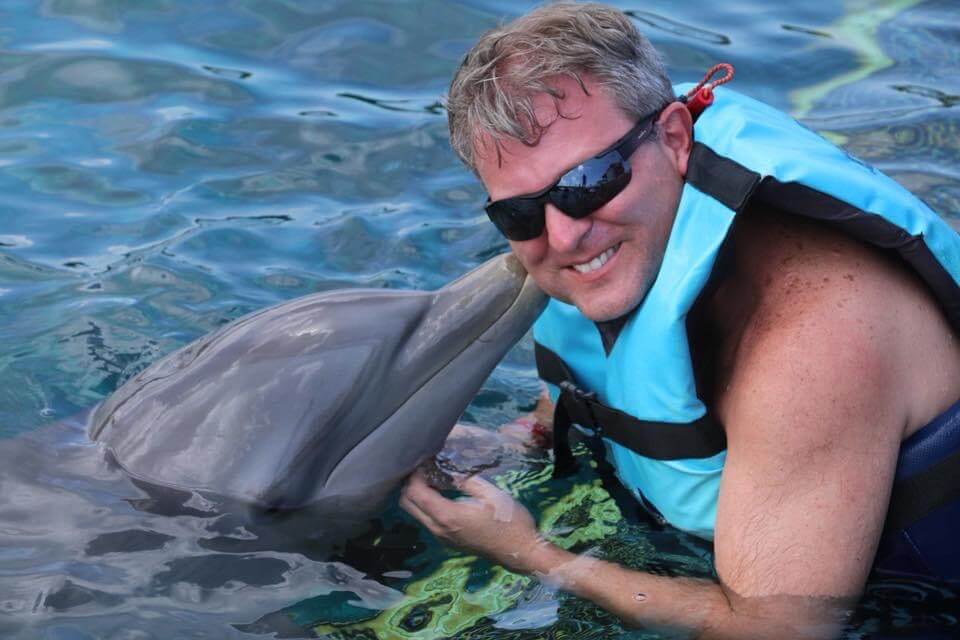 Man swimming with a dolphin