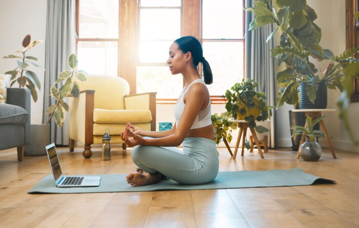 Photograph of Yoga fitness meditation and woman on laptop for the article Is your business IT FIT for 2024