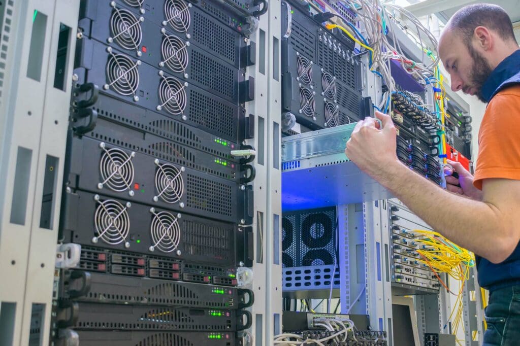 Man checking server in a network rack